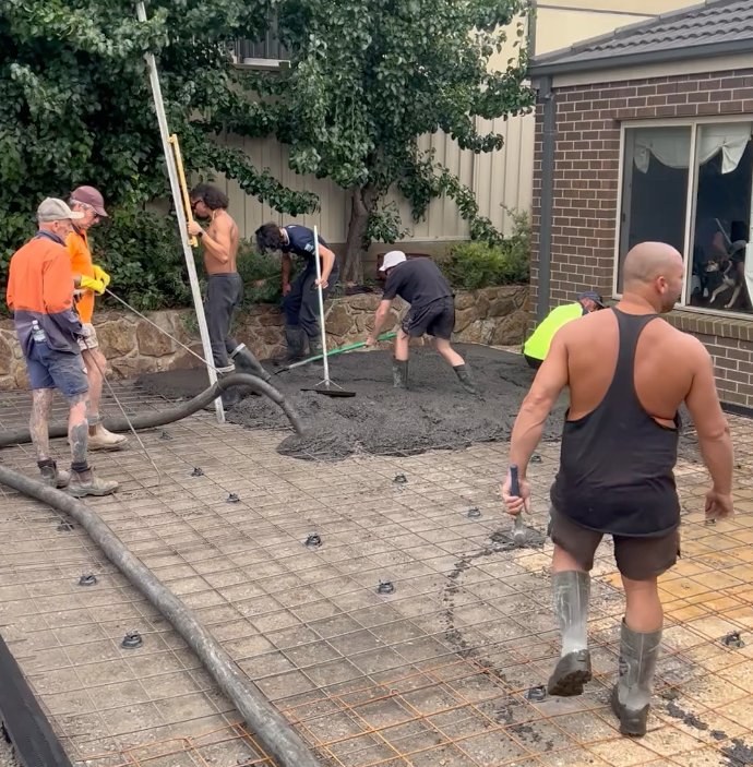 Curved concrete driveway with drainage channels clearly visible — Melbourne Concreting Solutions