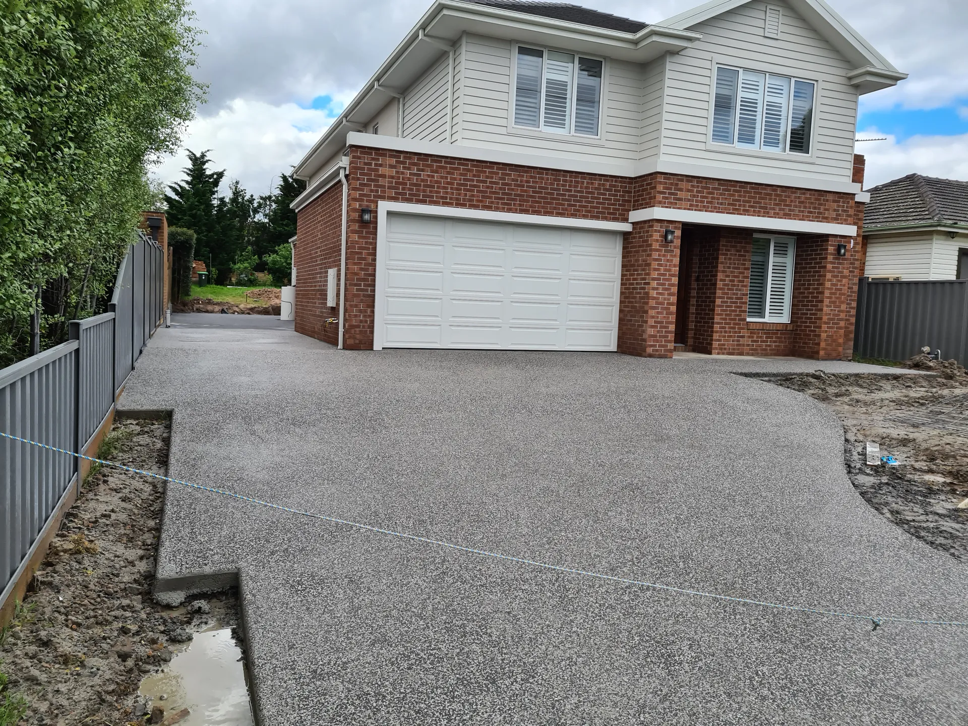 Completed exposed aggregate driveway — clean handover, spotless site